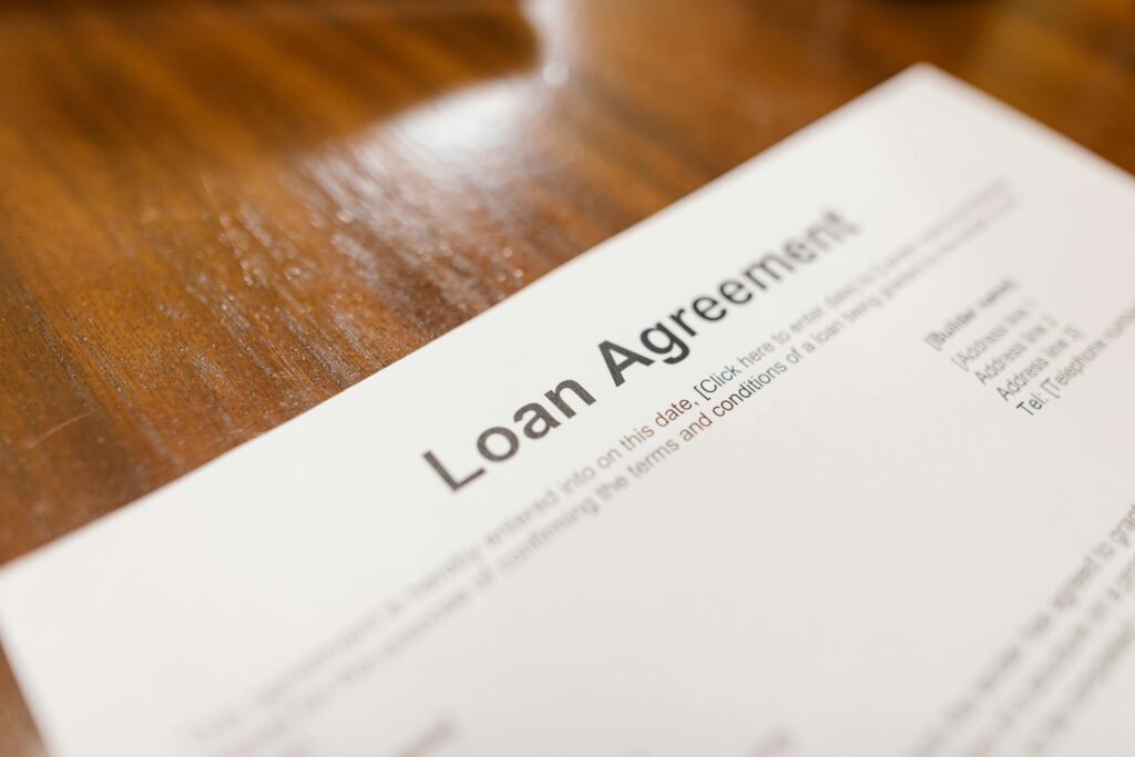Close-up of a loan agreement document on a wooden table, representing considerations for when a payday loan might be the right solution.