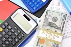 Personal loan interest rate calculation with calculator, cash, and financial documents