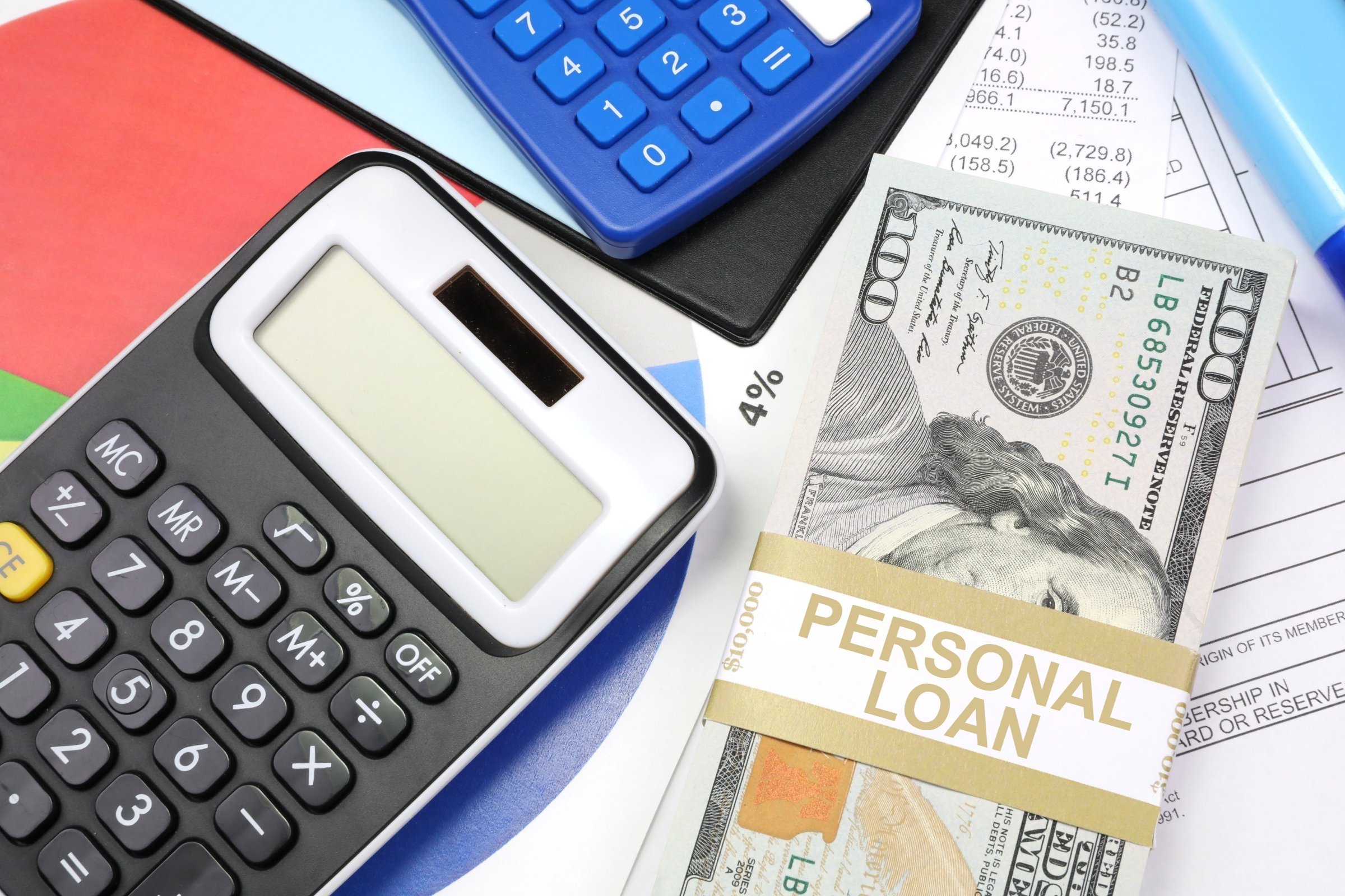 Personal loan interest rate calculation with calculator, cash, and financial documents